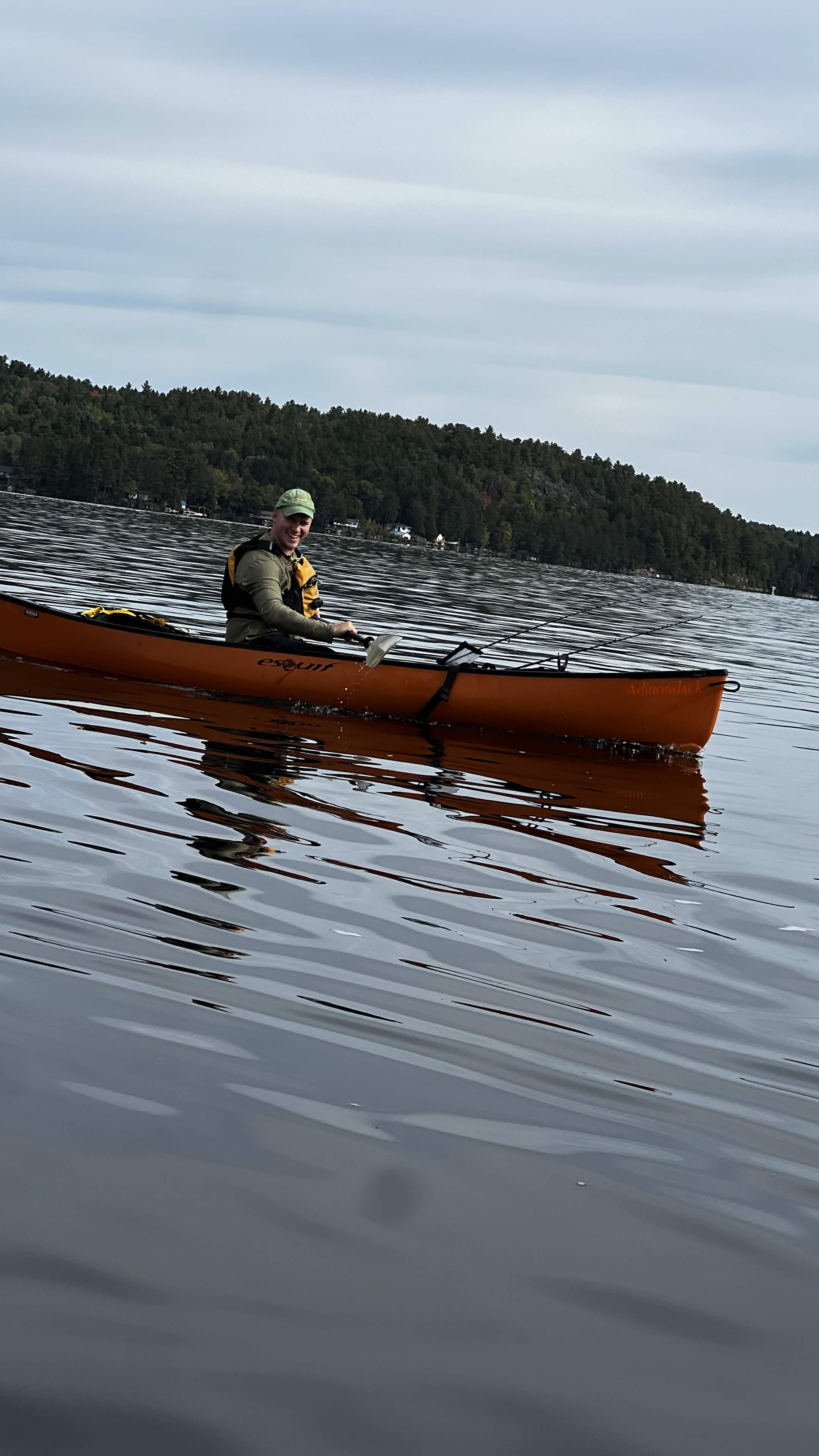 One of the owners paddling a canoe on a backcountry lake