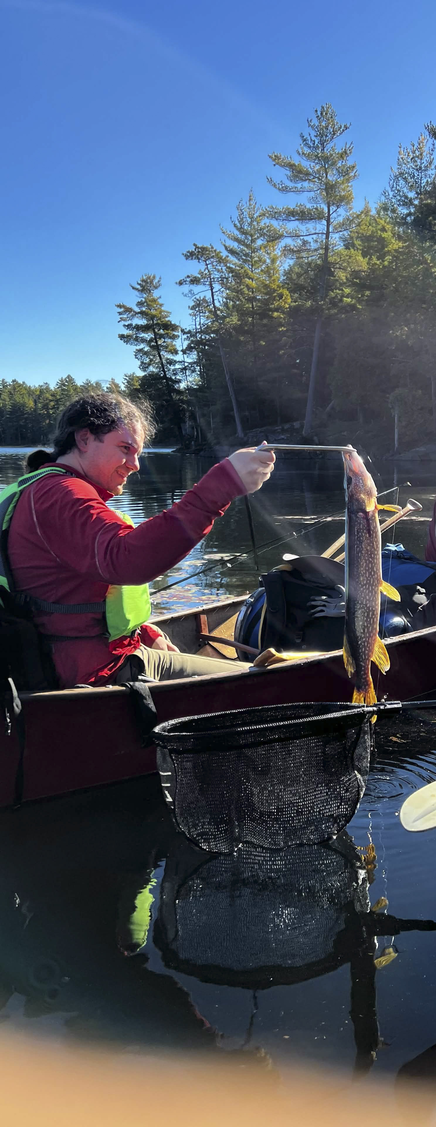 One of the owners with a pike from a backcountry fishing trip